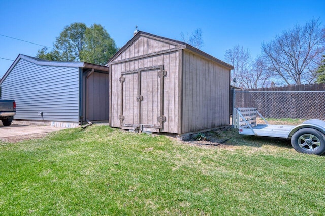 view of shed featuring fence