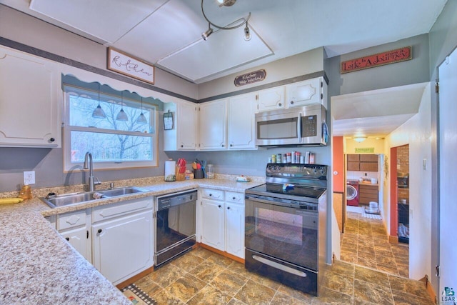 kitchen featuring black appliances, light countertops, white cabinets, and a sink