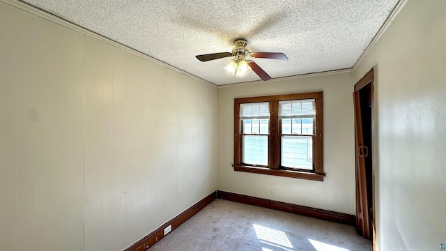 spare room with a textured ceiling, ceiling fan, light carpet, and baseboards