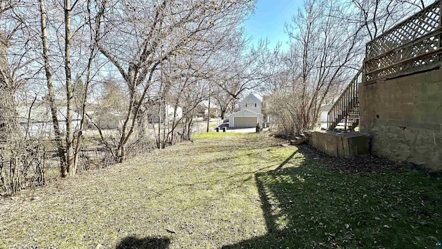 view of green lawn with stairway