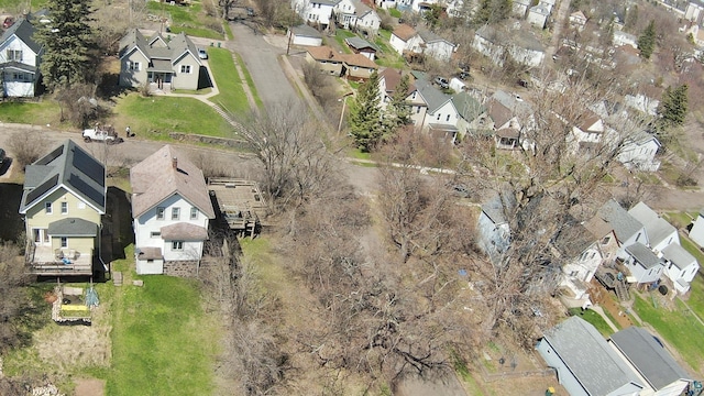 aerial view of property and surrounding area featuring nearby suburban area