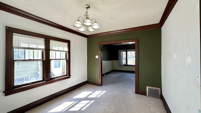 unfurnished room with crown molding, a textured ceiling, a chandelier, light carpet, and baseboards