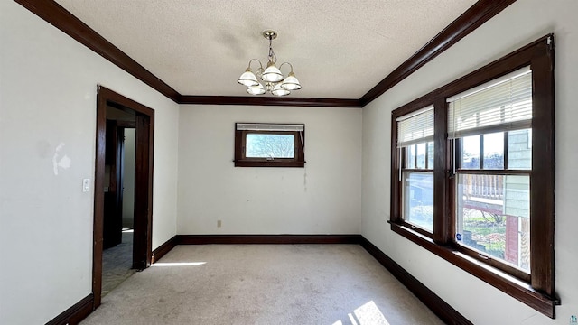 unfurnished room with ornamental molding, light carpet, a textured ceiling, a chandelier, and baseboards