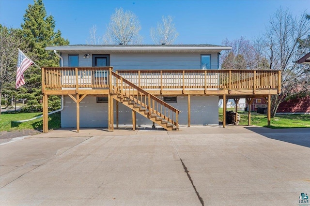 1514 14th St, Cloquet, MN 55720 - view of front of house with stairs, concrete driveway, a wooden deck, and a carport