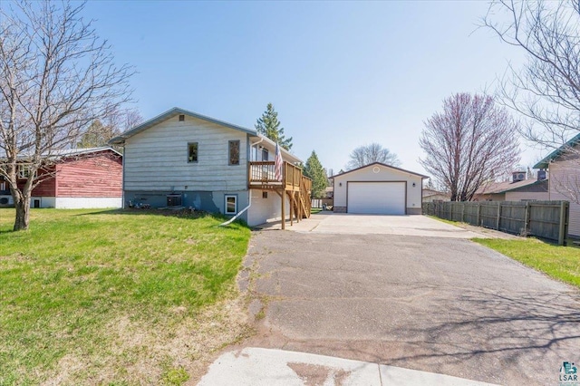 1514 14th St, Cloquet, MN 55720 - view of front facade featuring a detached garage, an outdoor structure, and a wooden deck