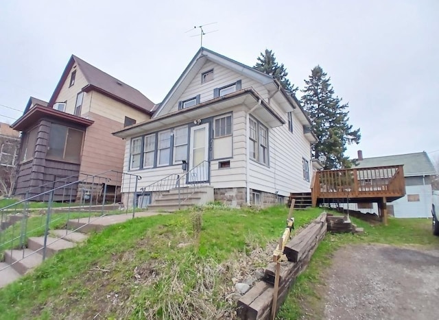 view of front of home with a wooden deck and entry steps