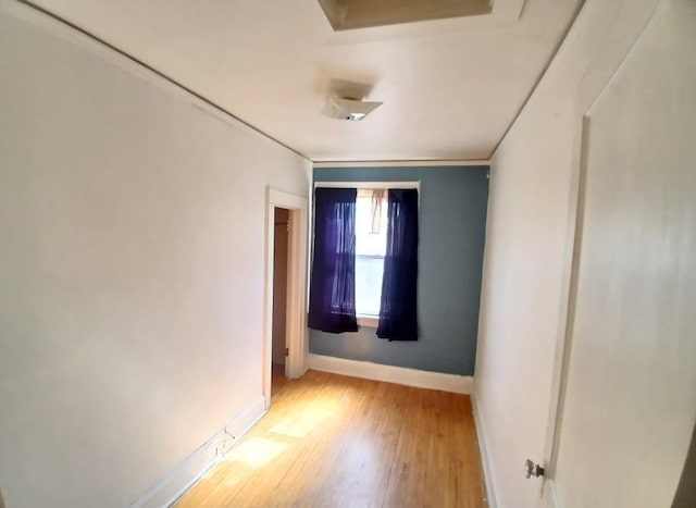 unfurnished room with baseboards and wood finished floors
