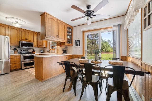 1741 Olsonville Crk, Carlton, MN 55718 - kitchen featuring stainless steel appliances, a peninsula, light countertops, and brown cabinetry