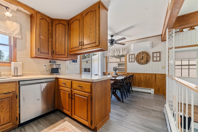 1741 Olsonville Crk, Carlton, MN 55718 - kitchen with dishwasher, a baseboard radiator, an AC wall unit, plenty of natural light, and wainscoting