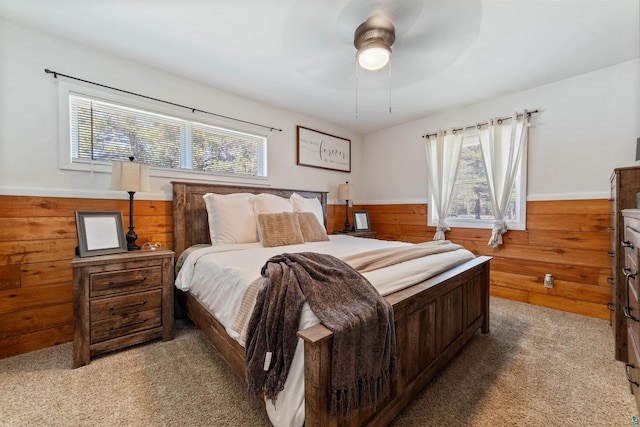 1741 Olsonville Crk, Carlton, MN 55718 - bedroom with wood walls, light colored carpet, a wainscoted wall, and a ceiling fan