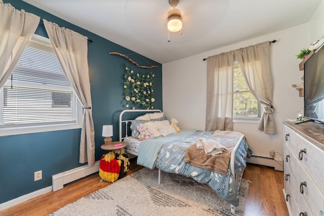 1741 Olsonville Crk, Carlton, MN 55718 - bedroom with a baseboard heating unit, a baseboard radiator, wood finished floors, ceiling fan, and lofted ceiling