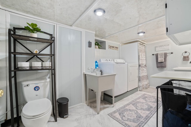 1741 Olsonville Crk, Carlton, MN 55718 - bathroom with washer and clothes dryer, marble look tiles, and toilet