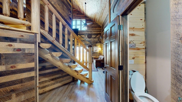 7498 Bayside Dr, Crane Lake, MN 55725 - stairs with hardwood / wood-style floors, wooden ceiling, wood walls, and high vaulted ceiling
