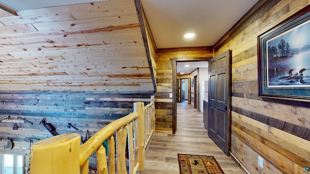 7498 Bayside Dr, Crane Lake, MN 55725 - corridor with wood walls, light wood-style floors, an upstairs landing, and recessed lighting