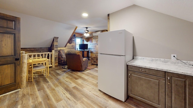 7498 Bayside Dr, Crane Lake, MN 55725 - kitchen featuring freestanding refrigerator, lofted ceiling, ceiling fan, light wood-style floors, and dark brown cabinetry