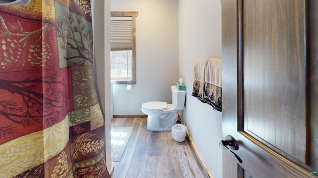 7498 Bayside Dr, Crane Lake, MN 55725 - bathroom with wood finished floors, toilet, and baseboards