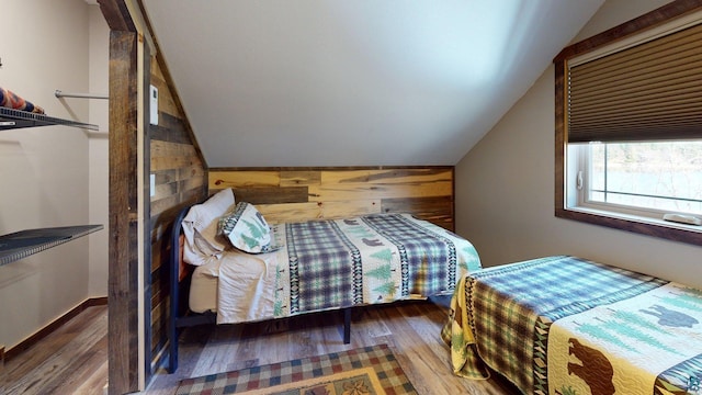 7498 Bayside Dr, Crane Lake, MN 55725 - bedroom with wooden walls, vaulted ceiling, and wood finished floors