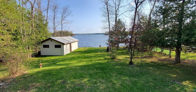 5729 Puncher Point Rd, Tower, MN 55790 - view of grassy yard with a water view and an outbuilding