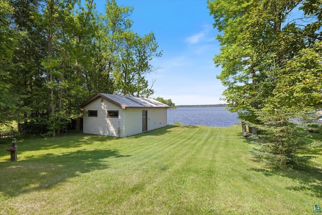 5729 Puncher Point Rd, Tower, MN 55790 - view of grassy yard featuring a water view and an outdoor structure