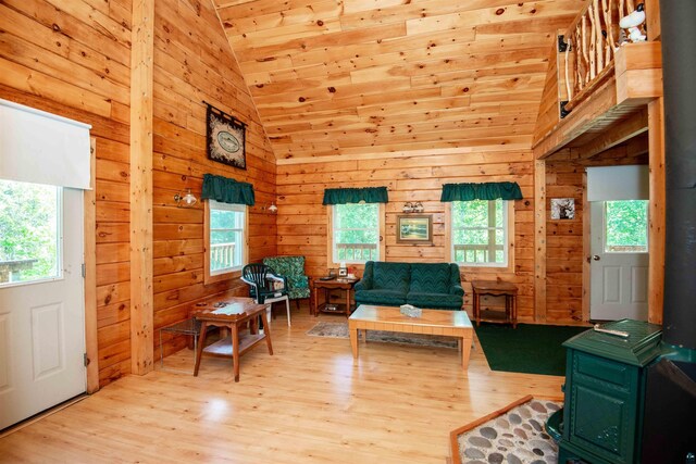 1808 Tom Lake Rd, Hovland, MN 55606 - sitting room with wood finished floors, a wood stove, high vaulted ceiling, wooden walls, and wooden ceiling