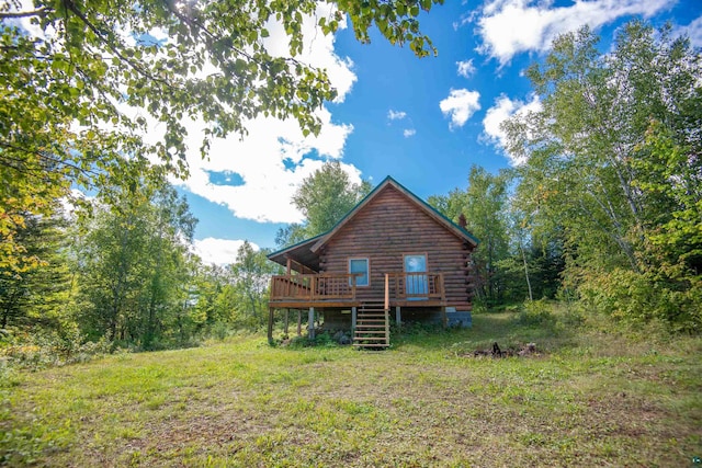 1808 Tom Lake Rd, Hovland, MN 55606 - rear view of property with log siding, a wooden deck, stairs, and a chimney