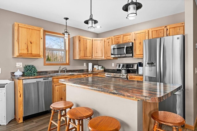 7070 Rice Lake Rd, Duluth, MN 55803 - kitchen with stainless steel appliances, a sink, a breakfast bar, and a center island