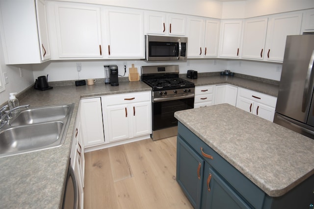 500 W 5th St, Grand Marais, MN 55604 - kitchen with appliances with stainless steel finishes, a sink, blue cabinets, and white cabinetry