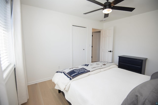 500 W 5th St, Grand Marais, MN 55604 - bedroom with wood finished floors, baseboards, a ceiling fan, and a closet