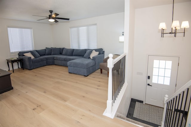 500 W 5th St, Grand Marais, MN 55604 - living room with light wood-type flooring, a chandelier, and a ceiling fan