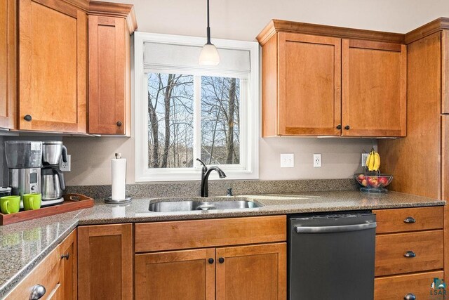 kitchen featuring dishwashing machine, a sink, brown cabinetry, and pendant lighting