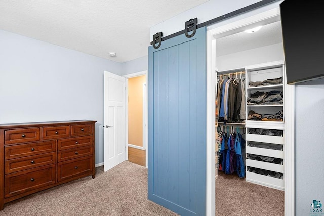 carpeted bedroom featuring a closet and a textured ceiling