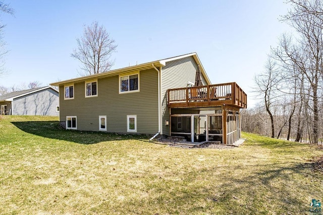back of house with a sunroom, a lawn, and a deck