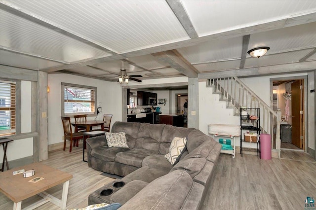 121 11th St, Cloquet, MN 55720 - living room featuring wood finished floors, stairs, baseboards, ceiling fan, and beamed ceiling