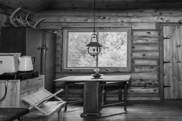 489 Brule Valley Trl, Hovland, MN 55606 - dining space featuring log walls, wood finished floors, wooden ceiling, and vaulted ceiling