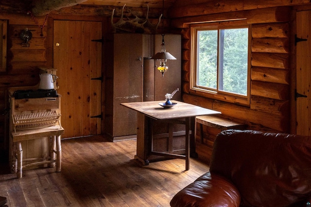 489 Brule Valley Trl, Hovland, MN 55606 - dining space featuring hardwood / wood-style flooring and log walls