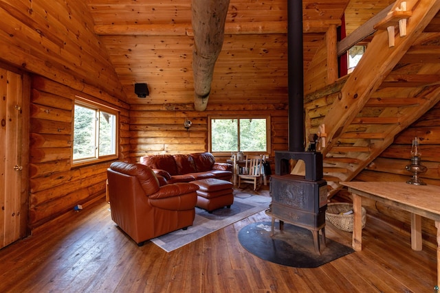 489 Brule Valley Trl, Hovland, MN 55606 - living area featuring a wood stove, hardwood / wood-style flooring, wood ceiling, and rustic walls