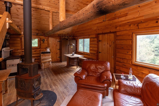 489 Brule Valley Trl, Hovland, MN 55606 - living room with a wood stove, wood-type flooring, wood ceiling, and log walls
