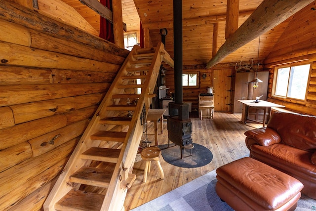 489 Brule Valley Trl, Hovland, MN 55606 - stairway with hardwood / wood-style flooring, a wood stove, plenty of natural light, wooden ceiling, and wooden walls