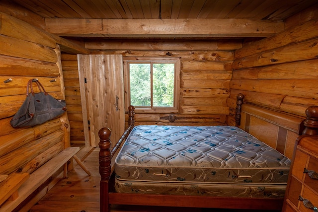 489 Brule Valley Trl, Hovland, MN 55606 - bedroom with wood ceiling, wood-type flooring, rustic walls, and beamed ceiling