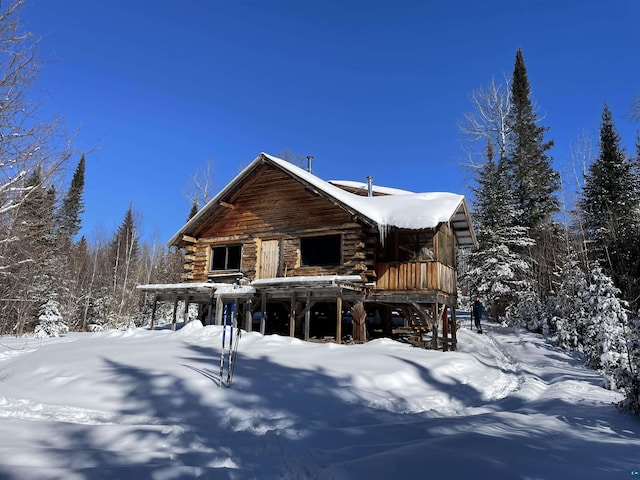 489 Brule Valley Trl, Hovland, MN 55606 - snow covered back of property featuring log exterior