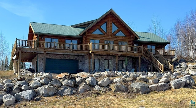 3165 Randa Rd, Cook, MN 55771 - back of house with a deck, stone siding, and a garage