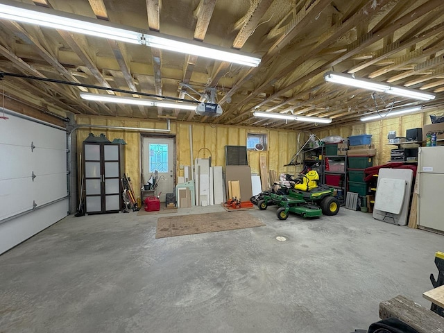 3165 Randa Rd, Cook, MN 55771 - garage featuring a garage door opener and freestanding refrigerator