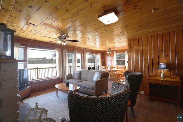 3165 Randa Rd, Cook, MN 55771 - living room featuring a ceiling fan, wooden ceiling, wood finished floors, healthy amount of natural light, and wood walls