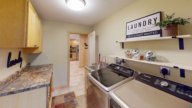 879 Clearwater Rd, Grand Marais, MN 55604 - laundry area featuring washing machine and dryer, cabinet space, and light tile patterned flooring