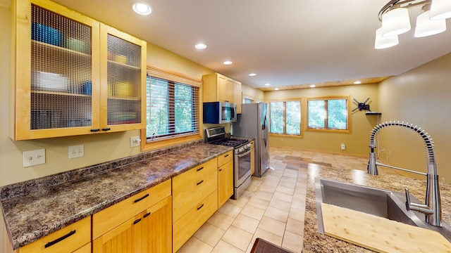 879 Clearwater Rd, Grand Marais, MN 55604 - kitchen featuring appliances with stainless steel finishes, a sink, light tile patterned flooring, recessed lighting, and glass insert cabinets