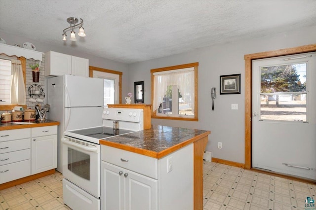 726 Laurel St, Cloquet, MN 55720 - kitchen featuring white appliances, light flooring, healthy amount of natural light, and a textured ceiling