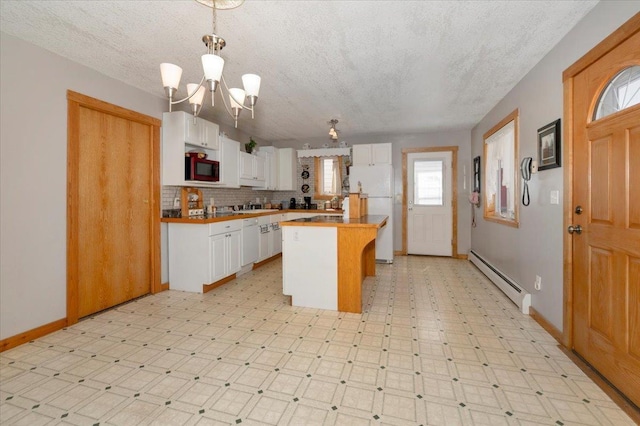 726 Laurel St, Cloquet, MN 55720 - kitchen with baseboard heating, white cabinets, a textured ceiling, a chandelier, and baseboards