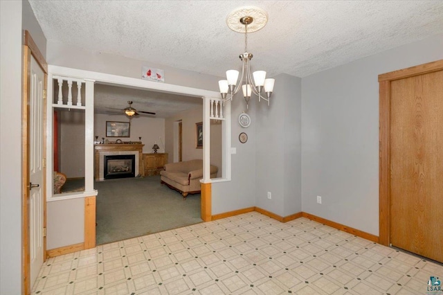 726 Laurel St, Cloquet, MN 55720 - unfurnished room featuring tile patterned floors, baseboards, a textured ceiling, a fireplace, and a ceiling fan