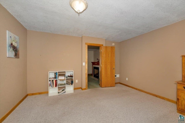 726 Laurel St, Cloquet, MN 55720 - unfurnished bedroom with a fireplace, baseboards, a textured ceiling, and carpet