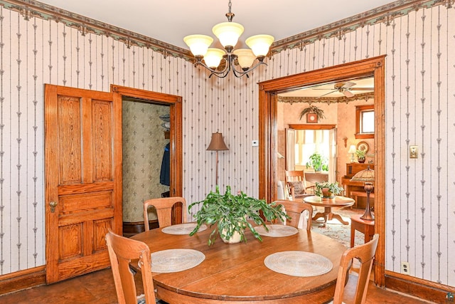 dining room with wallpapered walls, a chandelier, baseboards, and ceiling fan